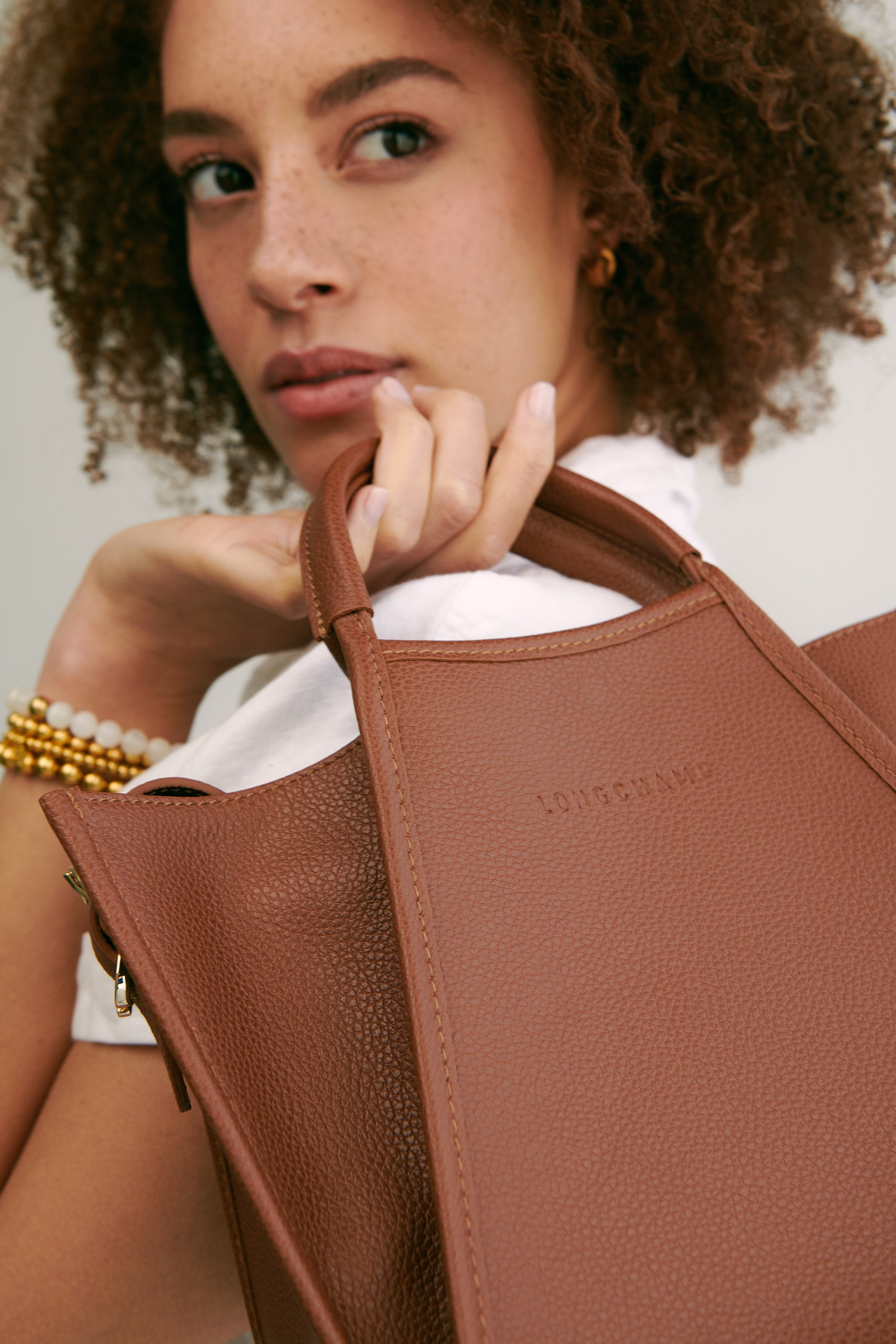 The Le Foulonné Top Handle Bag by Longchamp styled with the Zen Beaded Stretch Bracelet by Dean Davidson 