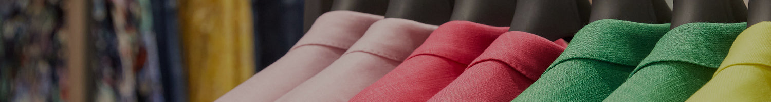 Banner of various coloured suit collars hanging on black clothes hangers. 