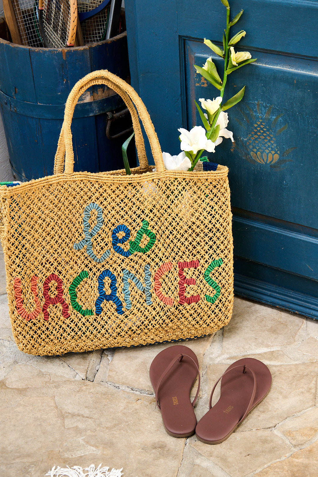 A woven jute tote from The Jacksons beside TKEES flip flops