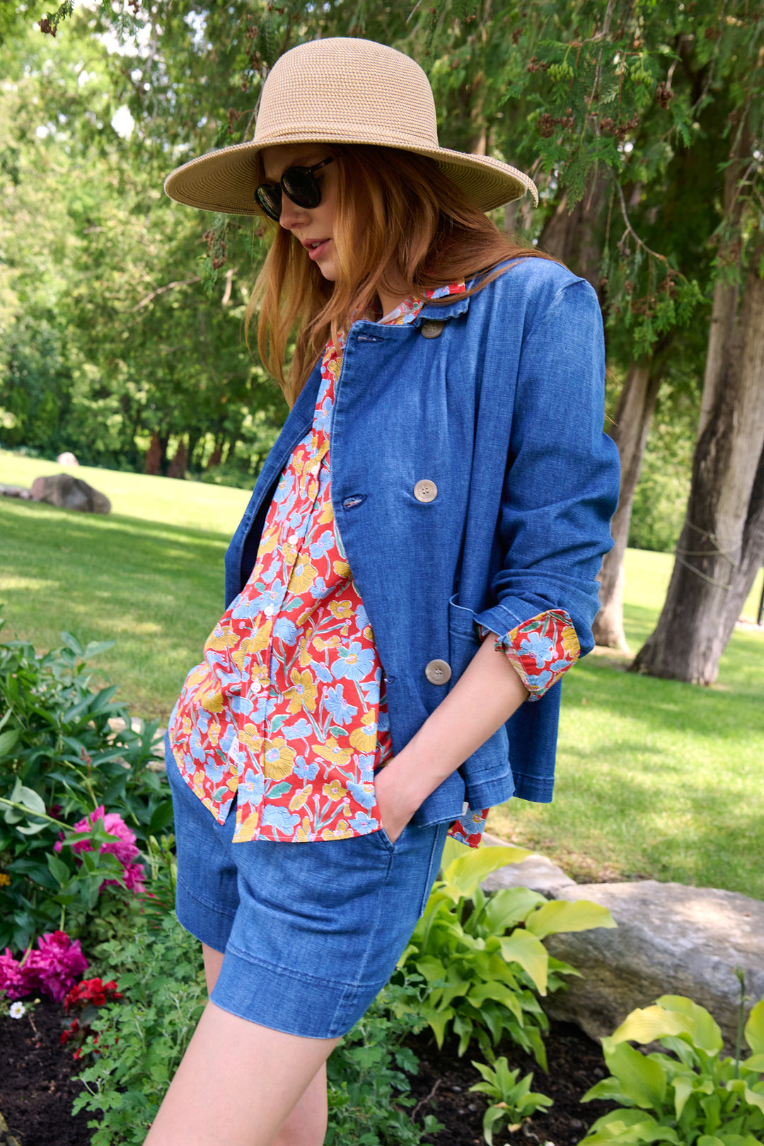 Close detail of a floral Frank & Eileen shirt, denim peacoat and wide-brim straw hat