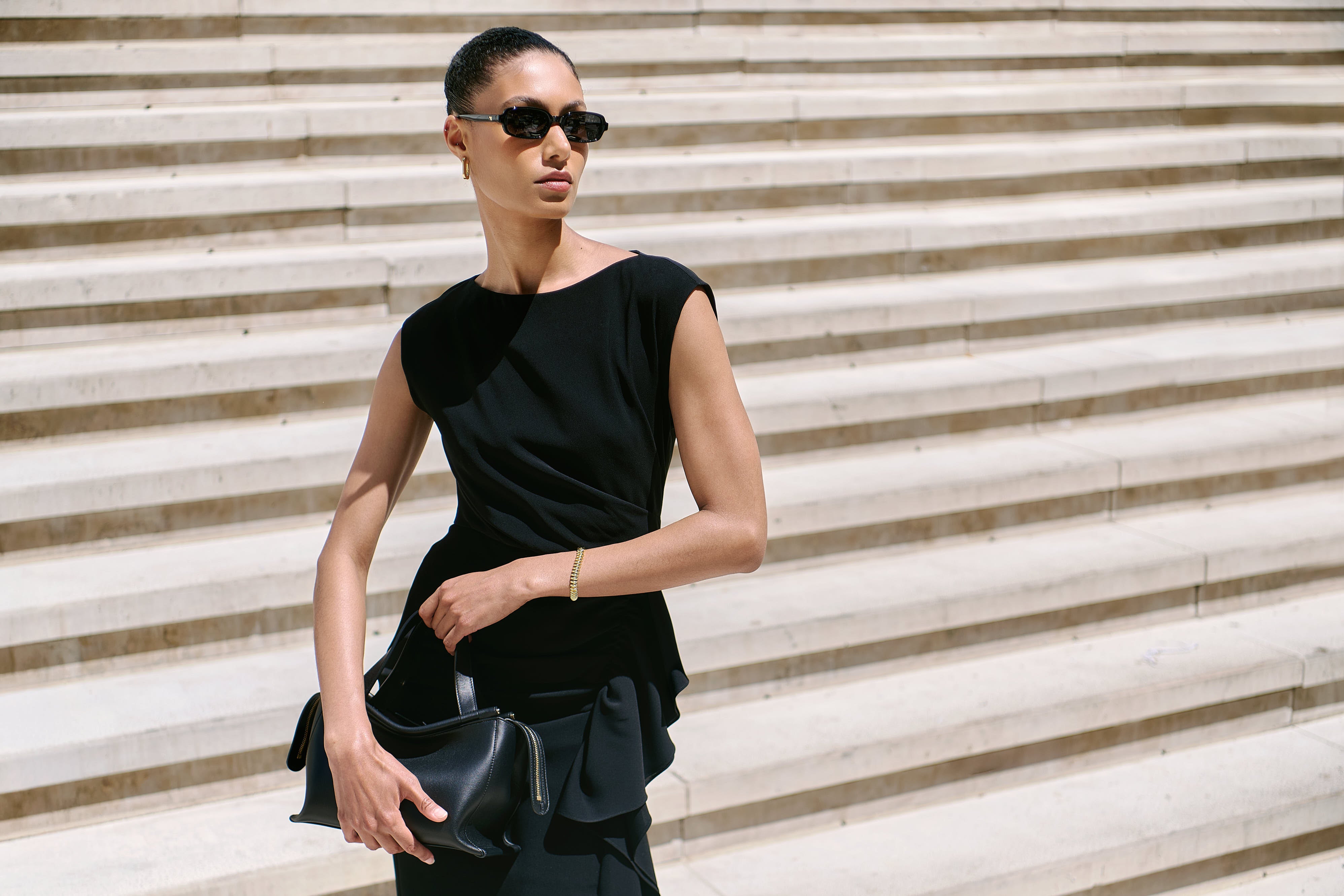 Model for Andrews Shops at First Canadian Place wears Max Mara Dress, styled with Wandler Ida Bag and Jenny Bird Jewelry 
