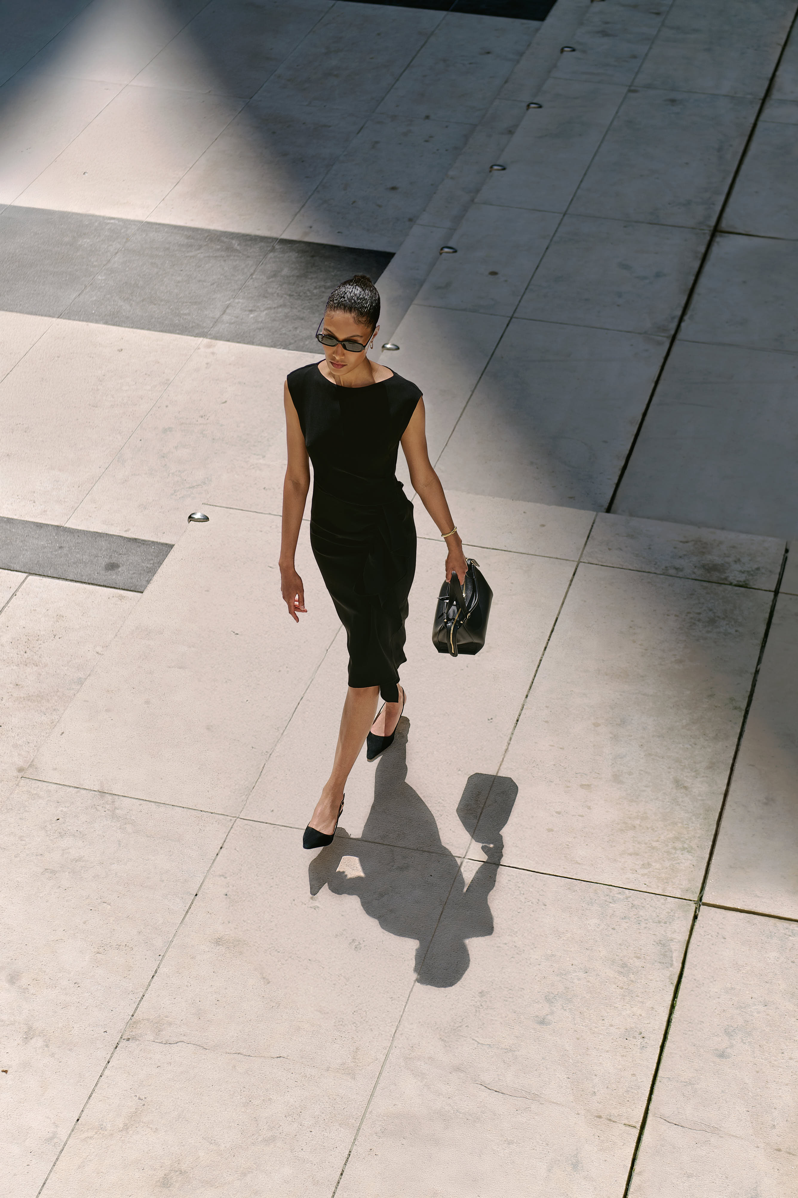 Model for Andrews Shops at First Canadian Place wears Max Mara Dress, styled with Wandler Ida Bag and Jenny Bird Jewelry 