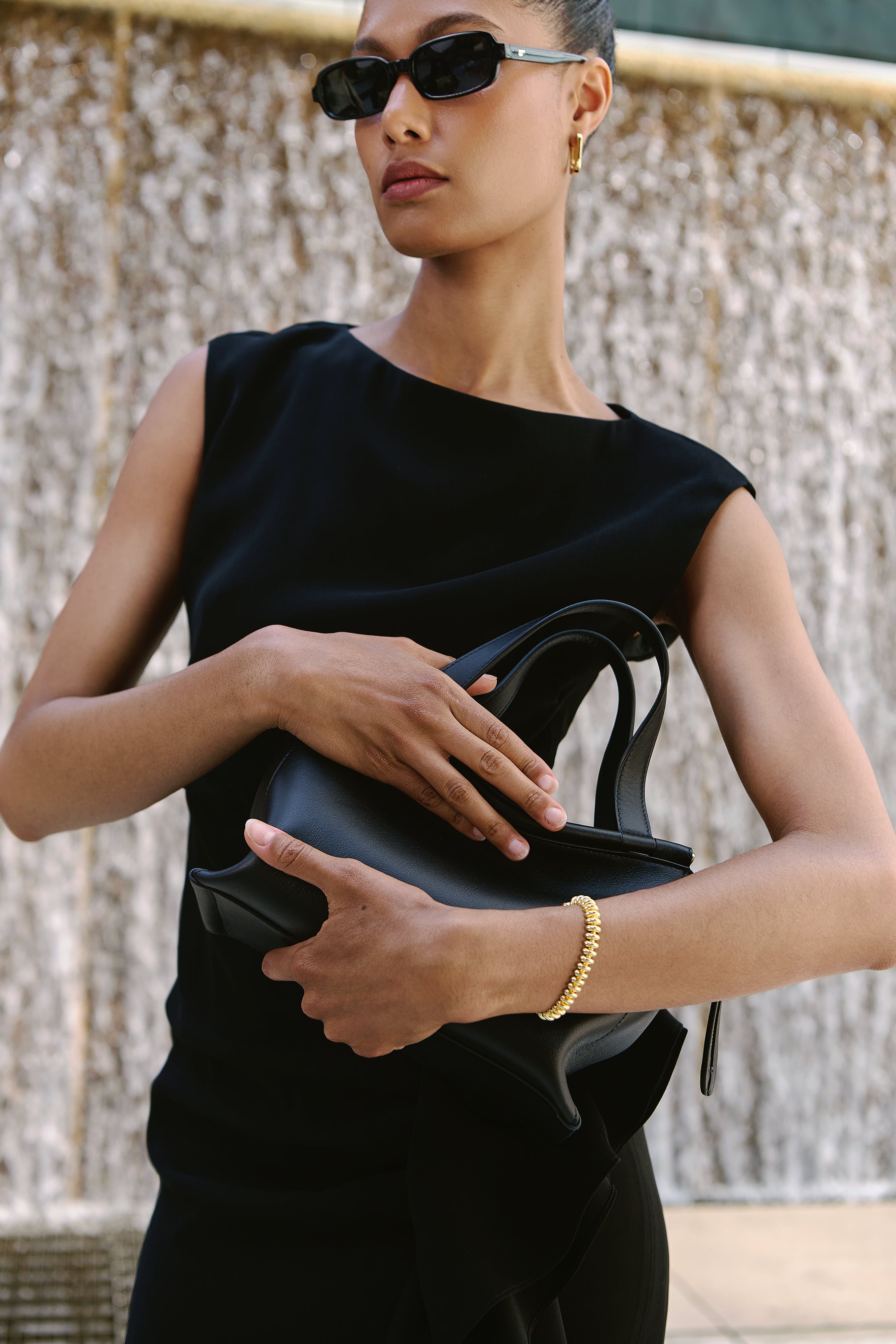 Model for Andrews Shops at First Canadian Place wears Max Mara Dress, styled with Wandler Ida Bag and Jenny Bird Jewelry 